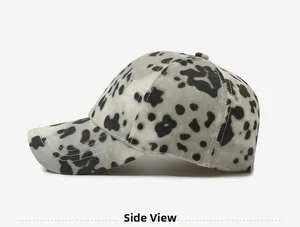 Side view of leopard print baseball cap with black and white spotted cotton fabric texture