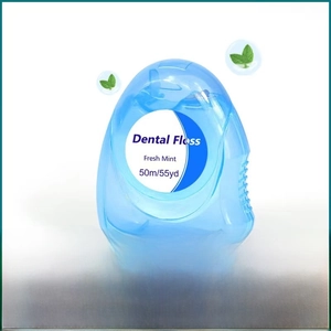 Detail of 50m mint-flavored dental floss in a semi-transparent blue portable box