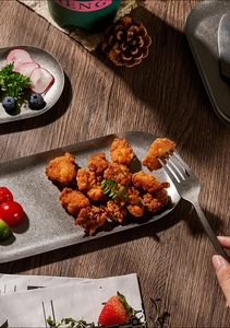 Close-up of fried chicken served on a retro oval 304 stainless steel snack plate