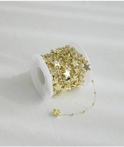 Detail of golden star bead chain roll for Christmas tree decoration and DIY crafts