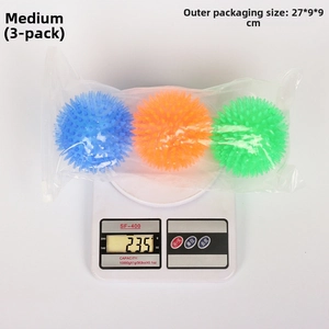Detailed view of three spiked TPR pet balls on an electronic scale showing 235g weight