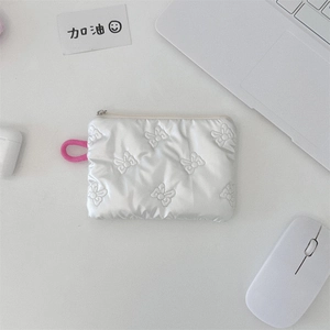 Close-up of silver quilted storage pouch with bow stitching and pink lanyard loop