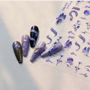 Detail of M-900 laser holographic nail stickers with purple snake and cloud motifs