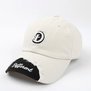 Detail of distressed brim with frayed edges and Different embroidery on baseball cap