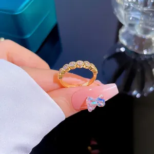 Macro shot of gold plated stackable ring with sparkling cubic zirconia pavé setting