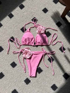 Pink bikini set with 3D rose flower accents and adjustable tie-up halter straps
