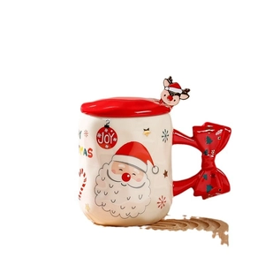 Christmas ceramic mug with red bow handle and Santa Claus illustration on white background