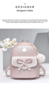 Detailed macro shot of pink PU leather backpack with bow accent and white plush ball charm