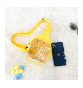 Detail of yellow PVC chest bag with colorful sequins and adjustable nylon strap