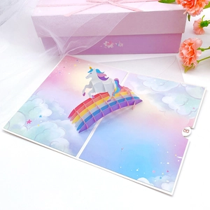 3D pop-up birthday card with unicorn and rainbow bridge theme on soft background