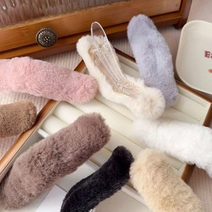 Close-up of soft faux fur hair clips in multiple colors like pink and beige