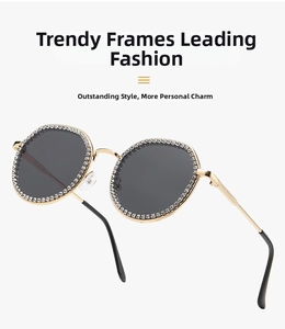 Detail of oversized gold metal round sunglasses with white crystal pavé frame and dark lenses