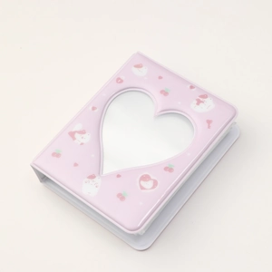 Detailed view of pink mini photo album featuring heart-shaped cutout and cute cherry prints