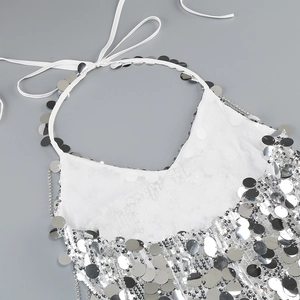 Detailed flat lay of silver sequin halter top featuring white straps and metallic finish
