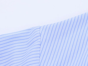 Close-up of the seam work and light blue fine striped cotton fabric on this shirt