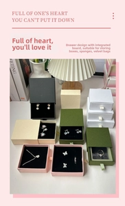 Detailed view of slide-out drawer jewelry boxes in forest green, pink, white, and black colors
