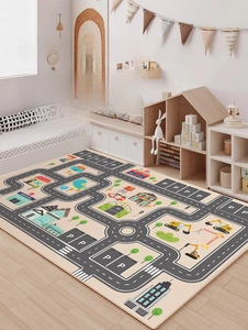 Close-up of soft road map play rug featuring construction trucks and city buildings