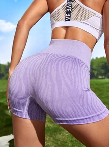 Outdoor back view of purple high-waisted yoga shorts with seamless tiger print design