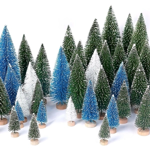 Close-up of mini flocked Christmas trees with snow effect and round wooden bases