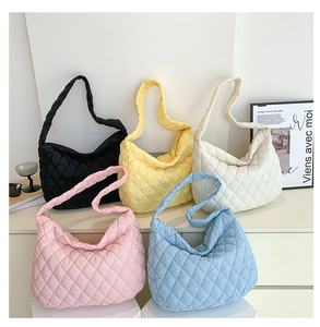 Detailed display of five colorful quilted puff shoulder bags in a professional still life set