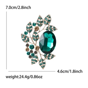 Vintage green crystal brooch with golden leaf design measuring 7.0cm for elegant coats