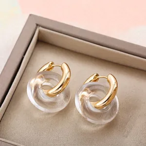 Minimalist gold stainless steel earrings with clear resin interlocking rings in a gift box