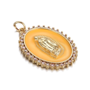 Macro view of gold oval pendant with yellow enamel Virgin Mary and pink crystals
