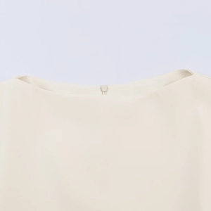 Chic beige bubble sleeve top featuring a detailed neckline with a hidden back zipper