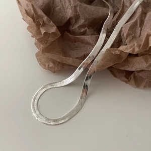 Minimalist 925 sterling silver 4mm flat snake chain necklace on brown paper backdrop