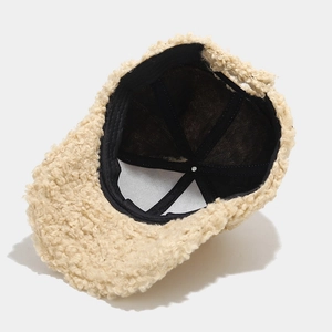 Beige faux shearling baseball cap showing black inner lining and reinforced seams