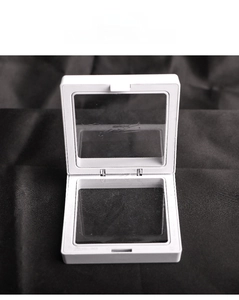 Close-up of a white square PE film suspension jewelry display box for rings and coins