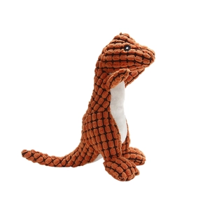 Detail of durable corn kernel texture fabric on orange plush dinosaur dog toy