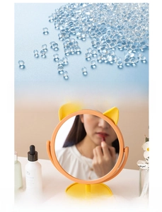 Macro shot of safe PP material pellets and yellow cat ear makeup mirror on desktop