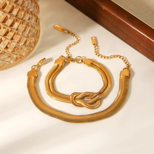 Polished 18k gold plated snake chain bracelet set with unique central knot design