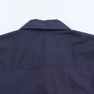 Close-up of navy blue poplin shirt showing high-density fabric texture and stitching details