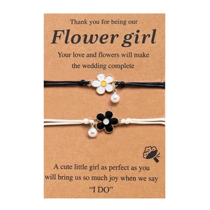 Detail of adjustable woven bracelets with enamel flowers and pearls on flower girl gift card