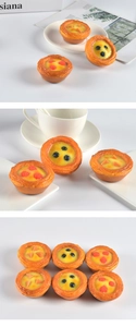 Detailed view of realistic artificial egg tarts with blueberry and peach toppings