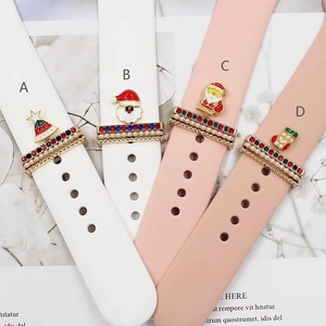Close-up of festive Christmas charms on silicone watch straps featuring Santa and trees