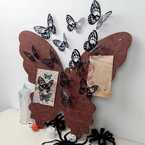 3D butterfly wall decor with black paper butterflies pinned on a brown skull base
