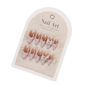 Handmade press-on nails with brown gradient French tips and 3D bow pearl accents