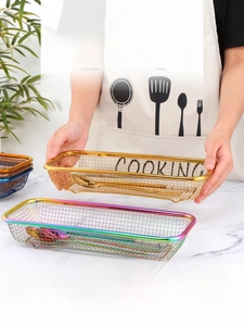 Macro detail of colorful stainless steel mesh baskets for kitchen utensil storage