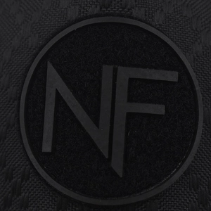 Macro shot of durable black grid fabric with circular rubber NF badge detail