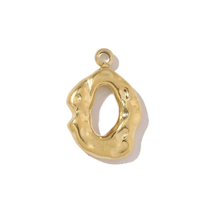 Close-up of golden stainless steel geometric pendant with hammered texture and metallic shine