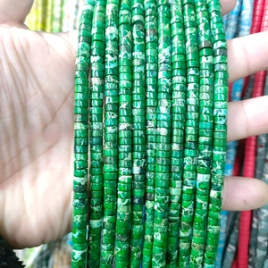 Macro shot of green natural stone spacer beads with vintage mottled patterns for DIY jewelry