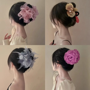 Four styles of large artificial flower and feather hair claws for elegant hair styling