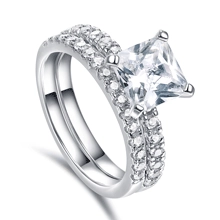 Detailed macro view of princess cut square diamond ring set in polished silver finish