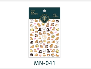 Detail showing cartoon Shiba Inu nail stickers with pink hearts on a white background