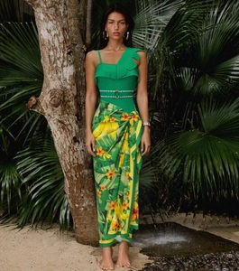 Detail of one-shoulder ruffle swimsuit with tropical print sarong and belted waistline