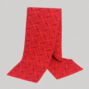 Detail of red wool scarf featuring traditional Chinese longevity patterns and woven textures