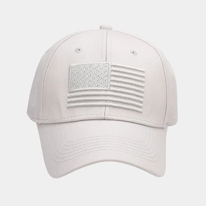 Detailed close-up of premium embroidered American flag on a light gray cotton baseball cap